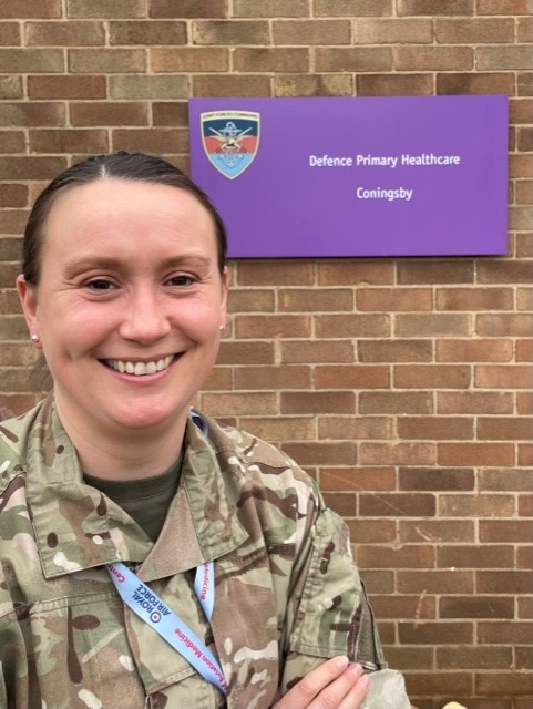 Smiling personnel outside medical facility.